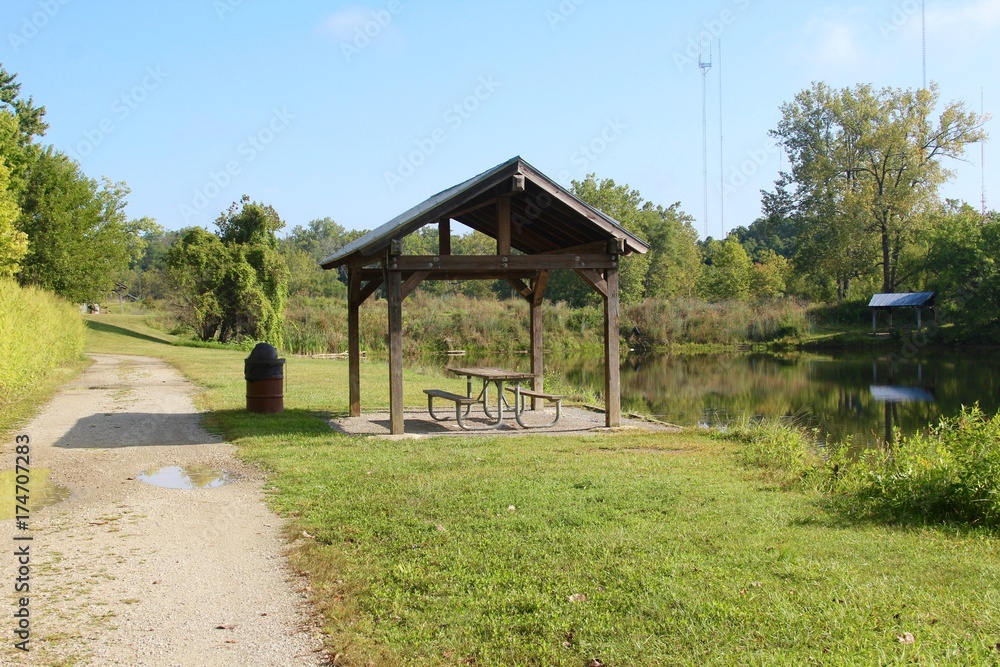 The small picnic shelter near the water of the lake.