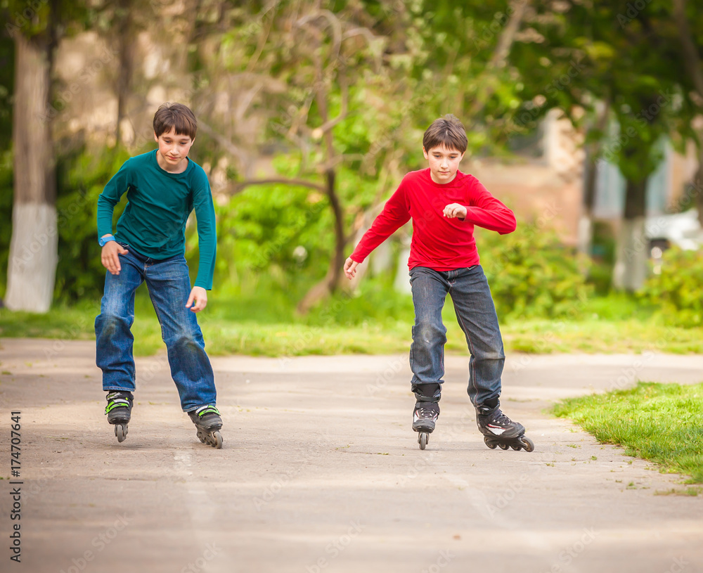 Three children on inline skates in park Three children on inline skates in park