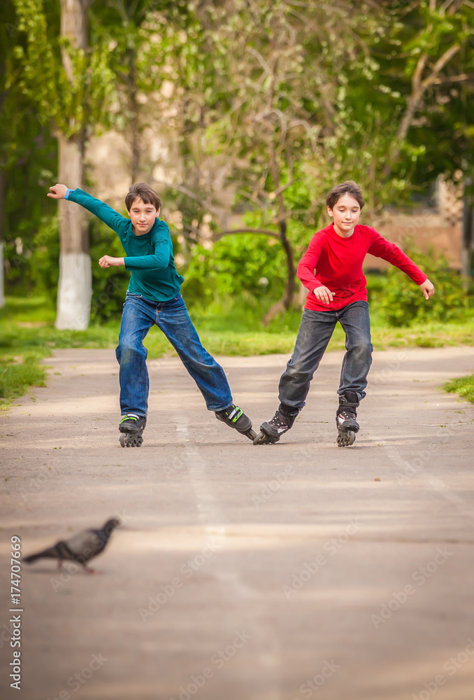 Three children on inline skates in park Three children on inline skates in park