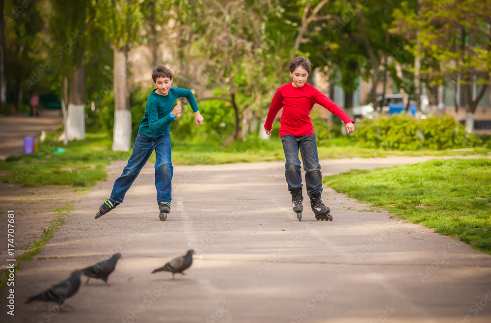 Three children on in line skates in park Three children on in line skates in park