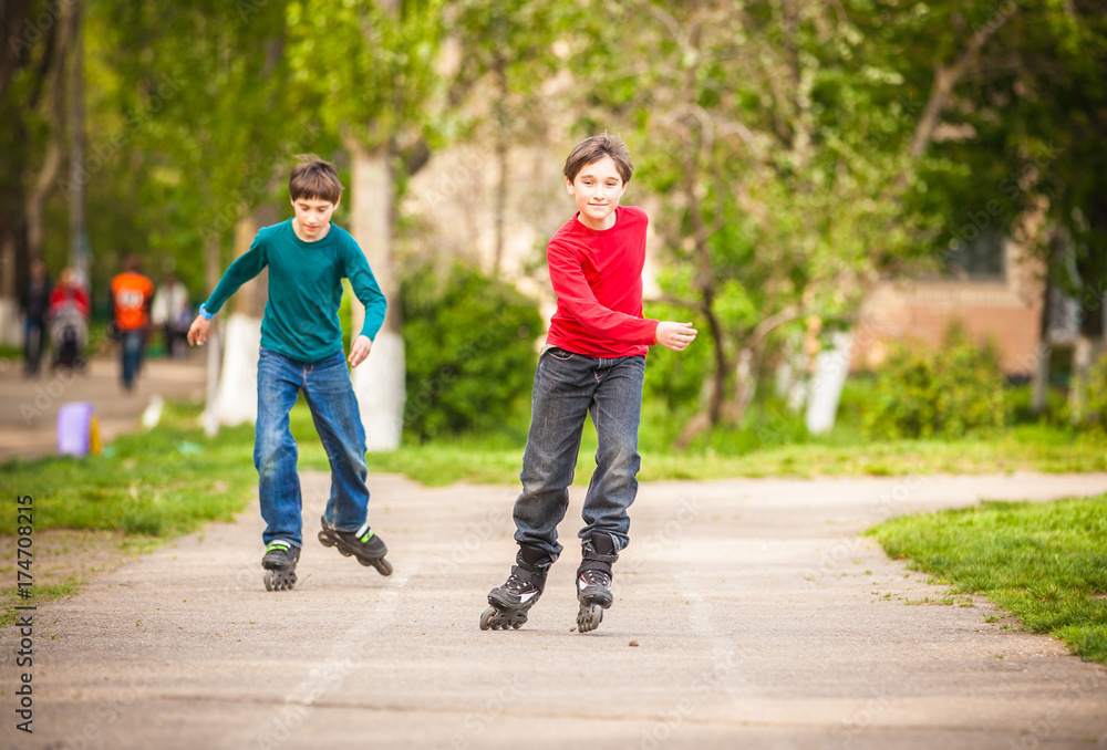 Three children on inline skates in park Three children on inline skates in park
