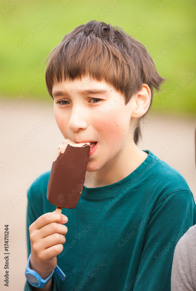 Portrait a young boy eating a tasty ice cream Portrait a young boy eating a tasty ice cream