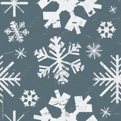 Vector seamless pattern with different graphic showflakes. Abstract winter background. White grunge texture snow on blue background.