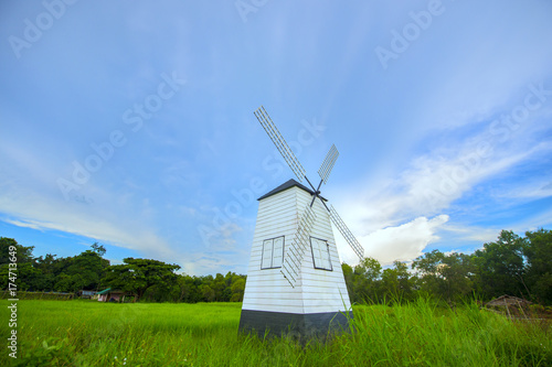 Turbine wooden house  and light of sunset in cloudy blue sky. © Prajakkit