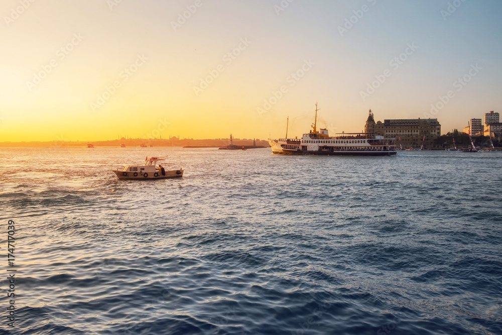 Evening Bosphorus sunset with boat and ferry Istanbul October