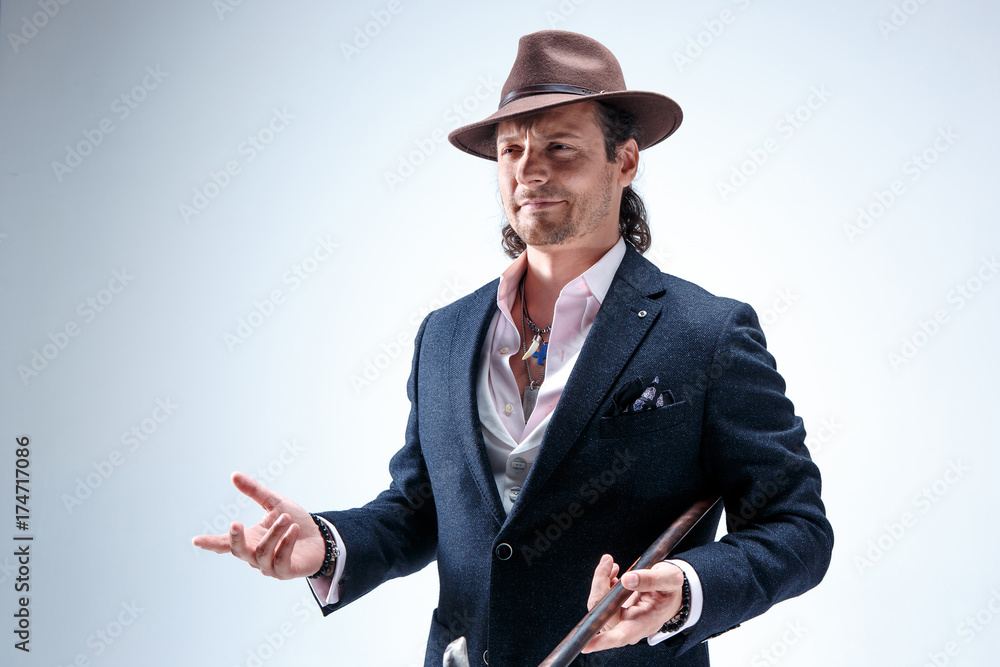 Young man portrait with hat on gray studio background. Young man portrait with hat on gray studio background.