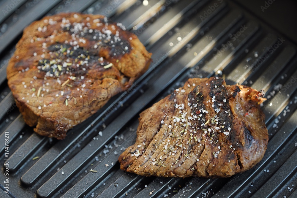 Tasty fresh grilled meats with spices and salt Tasty fresh grilled meats with spices and salt