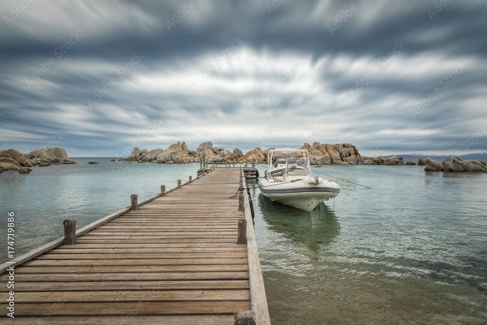 Boats moored to a jetty at Hotel des Pecheurs on Cavallo Island