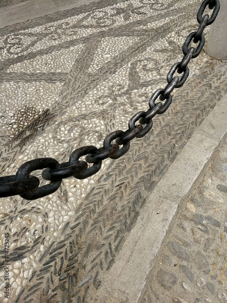 Chain and cobbled streets in Granada, Spain Chain and cobbled streets in Granada, Spain