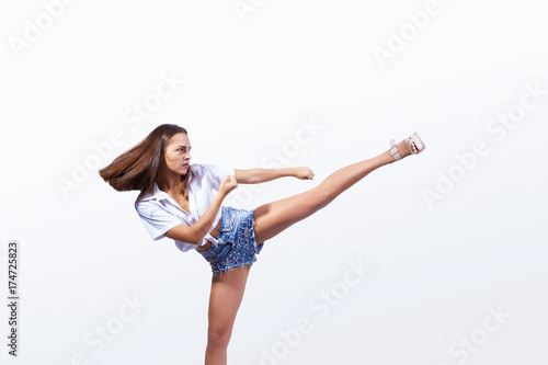 A girl in high-heeled shoes makes a high kick