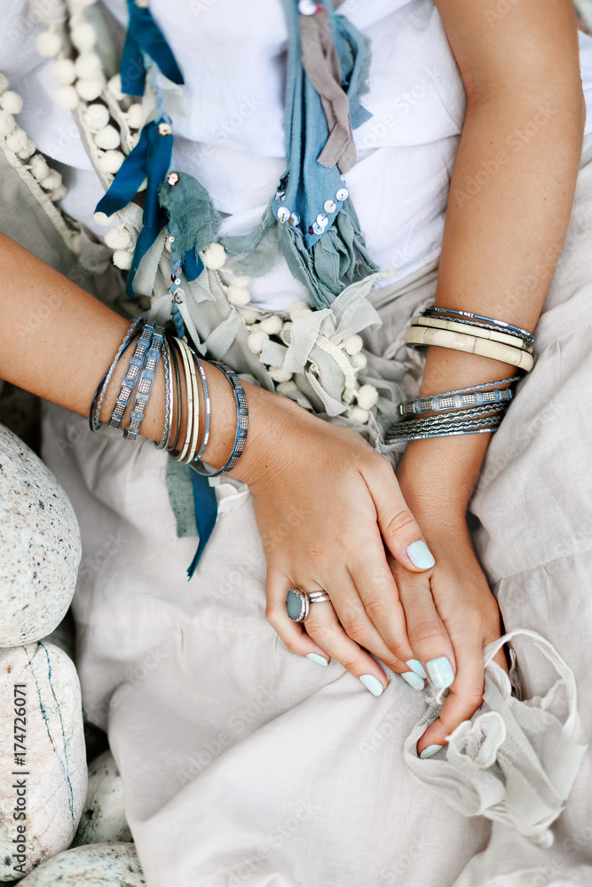 Obraz premium close up of boho styled woman hands with silver jewelry