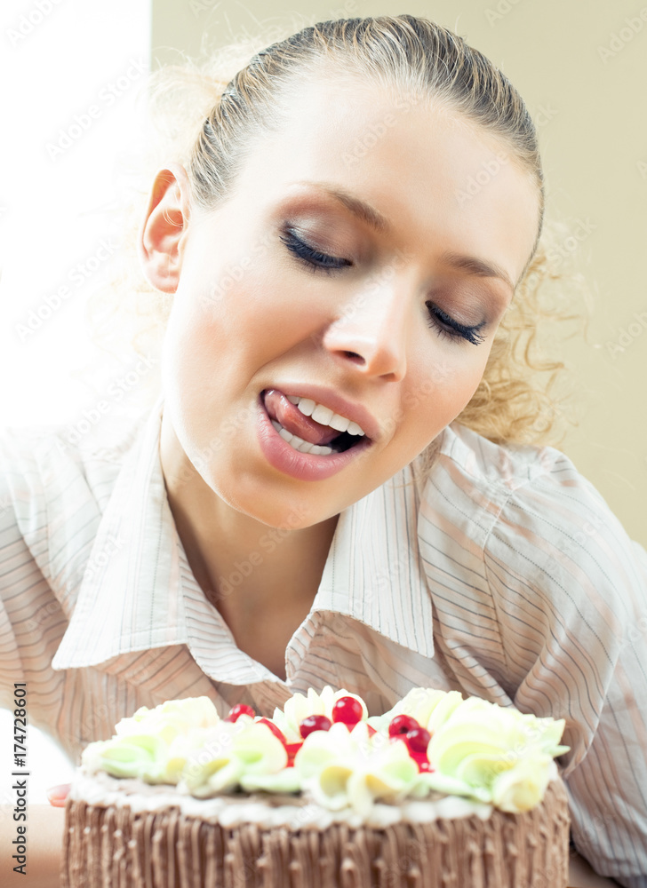 Cheerful blond young woman eating torte Cheerful blond young woman eating torte