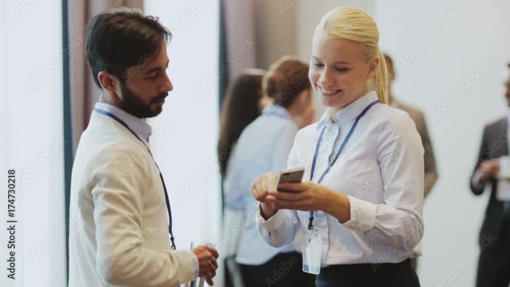 couple with smartphone at business conference couple with smartphone at business conference