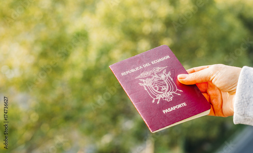 Someone holding a passport from the Republic of Ecuador, isolated. Ecuador is in South America photo