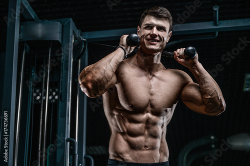 Handsome model young man training abs in gym © antondotsenko