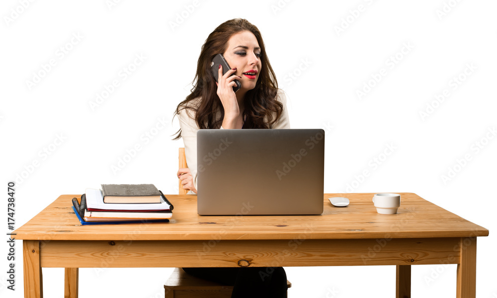 Business woman working with her laptop and with her mobile Business woman working with her laptop and with her mobile