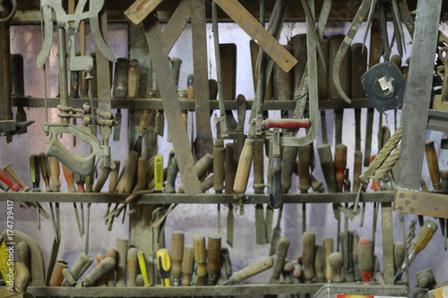 Carefully hanging hand tools in the metal workshop