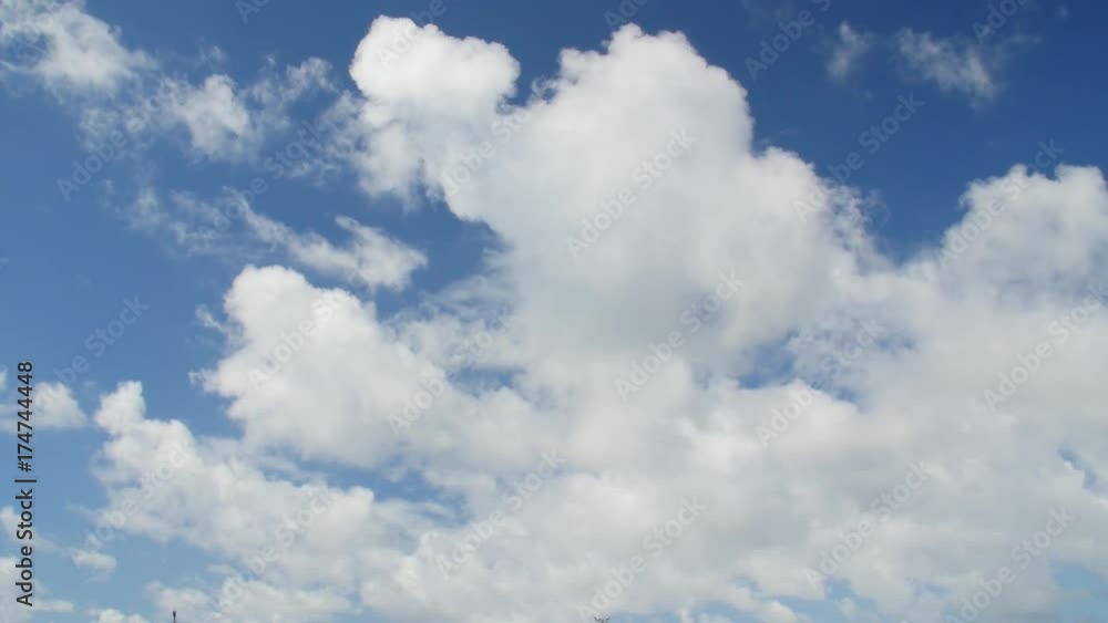 Time lapse clip of fast moving white fluffy clouds over blue sky. Time lapse clip of fast moving white fluffy clouds over blue sky.