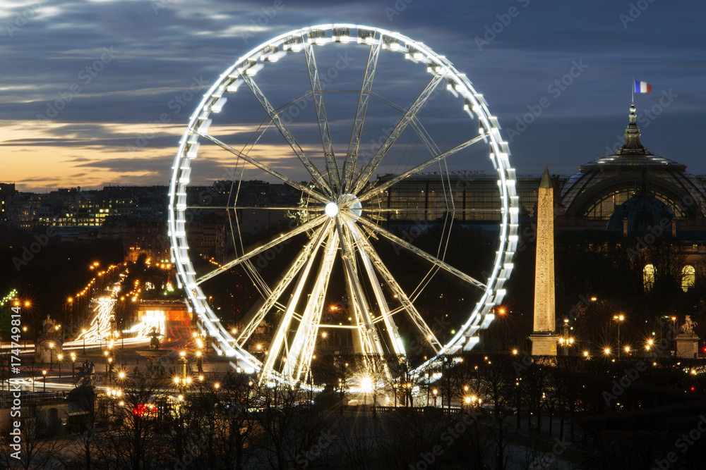 A view of ferris wheel and some historic buildings in Paris