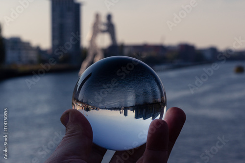 Canvas Print berlin skyline with molecule man monument shot through a glass sphere