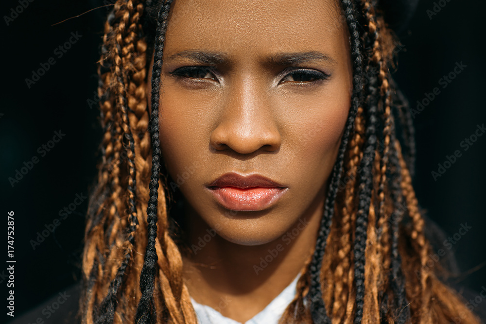 Unhappy woman portrait. Sad black female. Grumpy young girl on dark background, unimpressed facial expression, melancholy concept Unhappy woman portrait. Sad black female. Grumpy young girl on dark background, unimpressed facial expression, melancholy concept