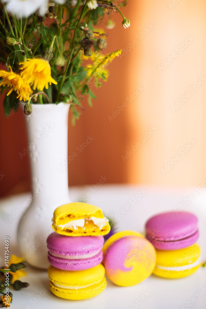 Symbol heart of flowers and macaroons on the light background. Top view. Text I love you Symbol heart of flowers and macaroons on the light background. Top view. Text I love you