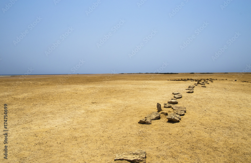 Obraz premium Landscape of the sandy desert with a line of stones. Ras Mohammed National Park
