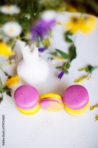 Symbol heart of flowers and macaroons on the light background. Top view. Text I love you