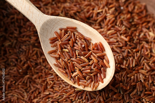 Wooden spoon with red Cargo rice, closeup