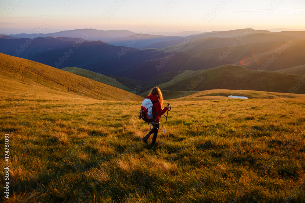 Girl tourist in mountain. Shot of a young woman looking at the landscape while hiking in the mountains. Travel inspiration and motivation, beautiful landscape.