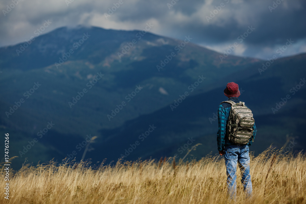 Man with backpack hiking in mountains. Beautiful natural landscape Man with backpack hiking in mountains. Beautiful natural landscape