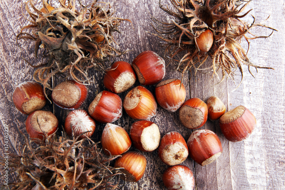 Hazelnut on wooden background. Tasty group of organic hazelnuts