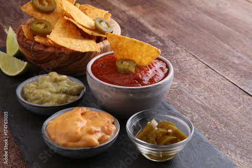 Nachos Tortilla Chips and jalape  os Chili Peppers or Mexican chili peppers with Tomato  Cheese and Guacamole dip