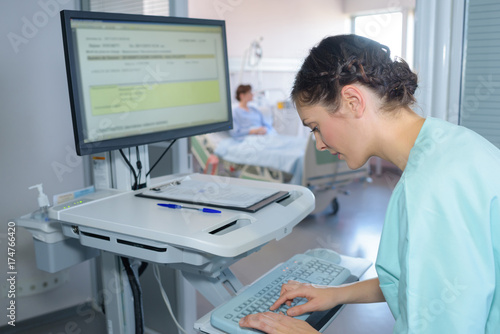 nurse entering prescription details onto a computer