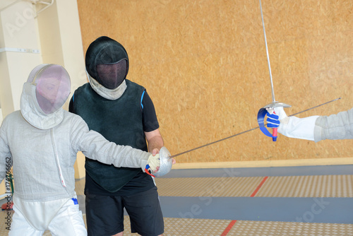 swordsmen trainining in a gym photo