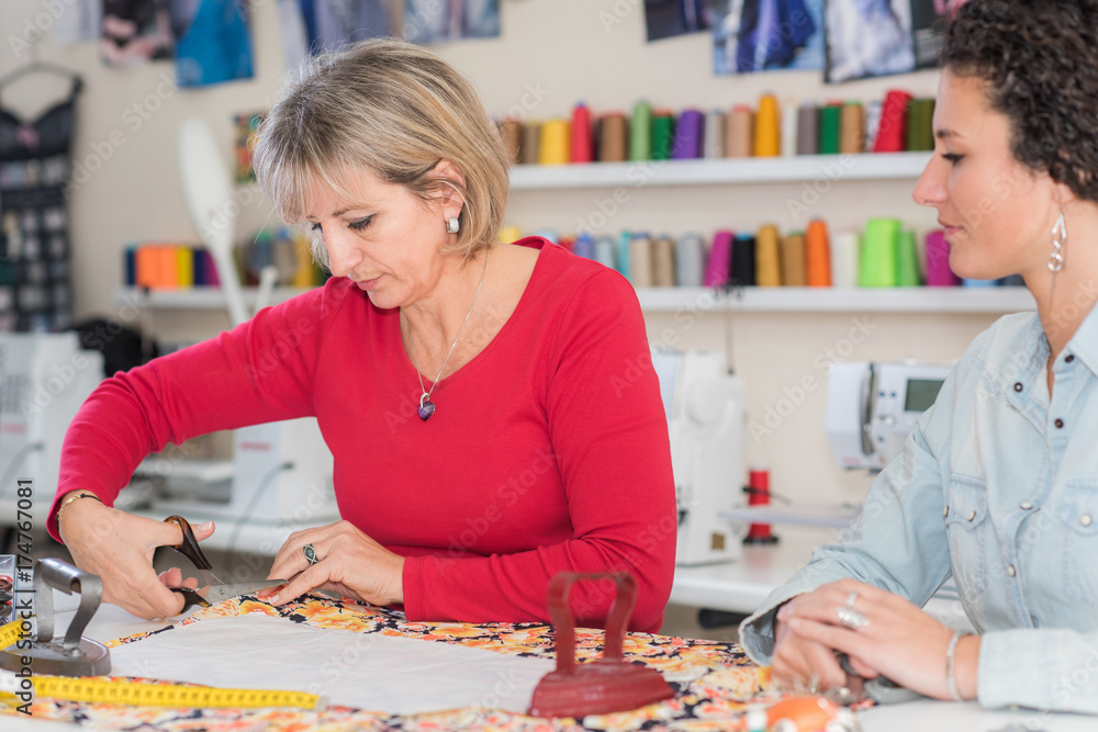 Fototapeta premium dressmaker at work making patterns of fabric