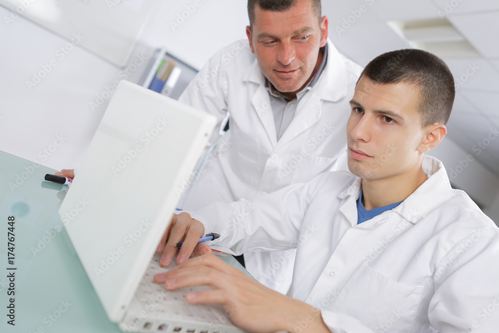 teacher helping student on project teacher helping student on project
