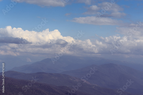 Mountains and blue sky with clouds, hipster landscape, toned