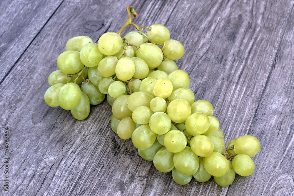 Fresh ripe white grapes on a wooden background. Fresh ripe white grapes on a wooden background.