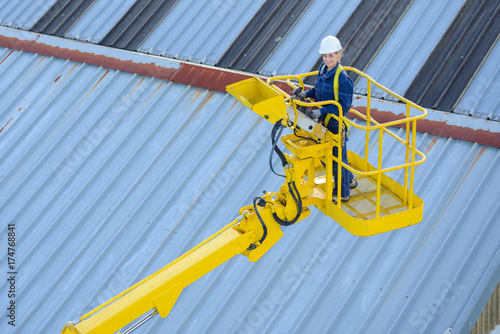 builder on a yellow aerial platform