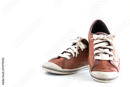 Old dirty sneaker on white background.Male Brown Leather Shoe.
