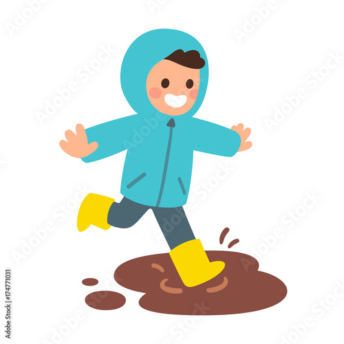Boy playing in mud puddle