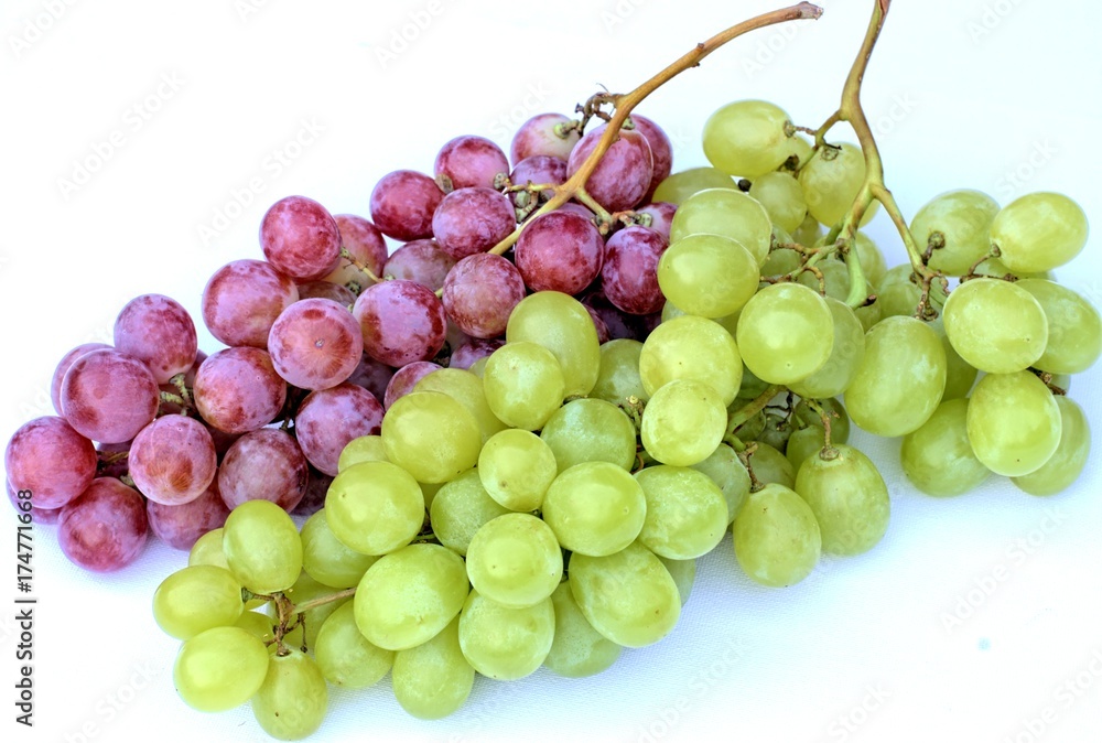 Ripe white and red grapes on a white background.