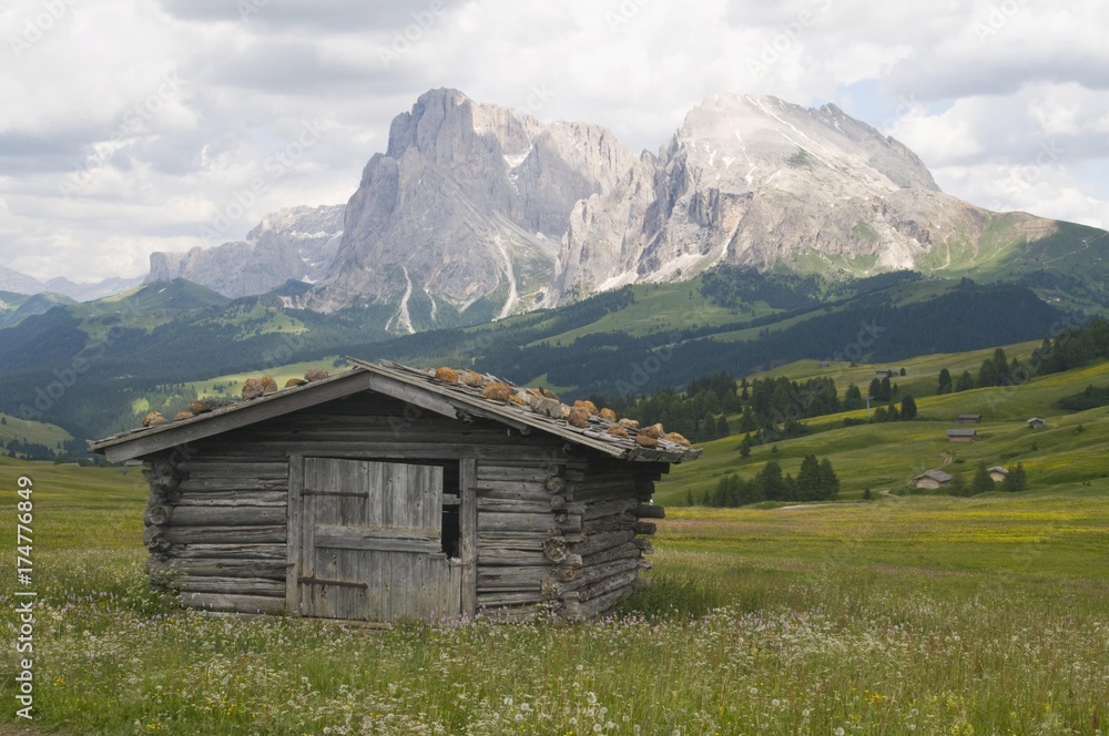 Alpine hut in front of Plattkofel and Langkofel mountains, Seiser Alm, South Tyrol, Italy, Europe Alpine hut in front of Plattkofel and Langkofel mountains, Seiser Alm, South Tyrol, Italy, Europe