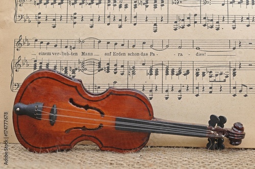 Toy violin in front of music sheet