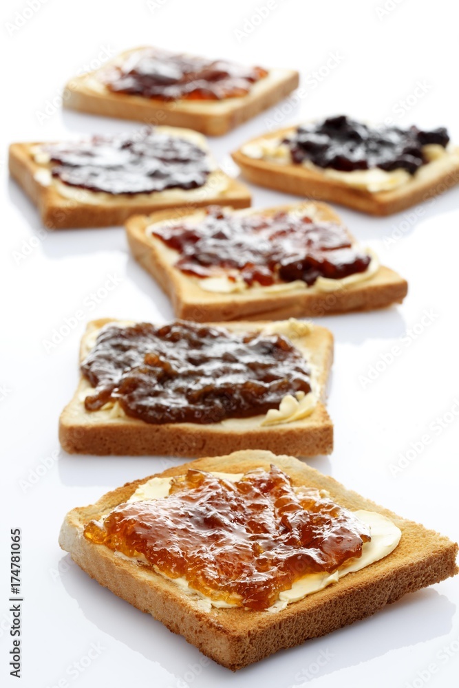 Six slices of toast with various jams, rhubarb jam, apricot jam, strawberry jam, orange marmalade, cherry jam and ginger marmalade Six slices of toast with various jams, rhubarb jam, apricot jam, strawberry jam, orange marmalade, cherry jam and ginger marmalade
