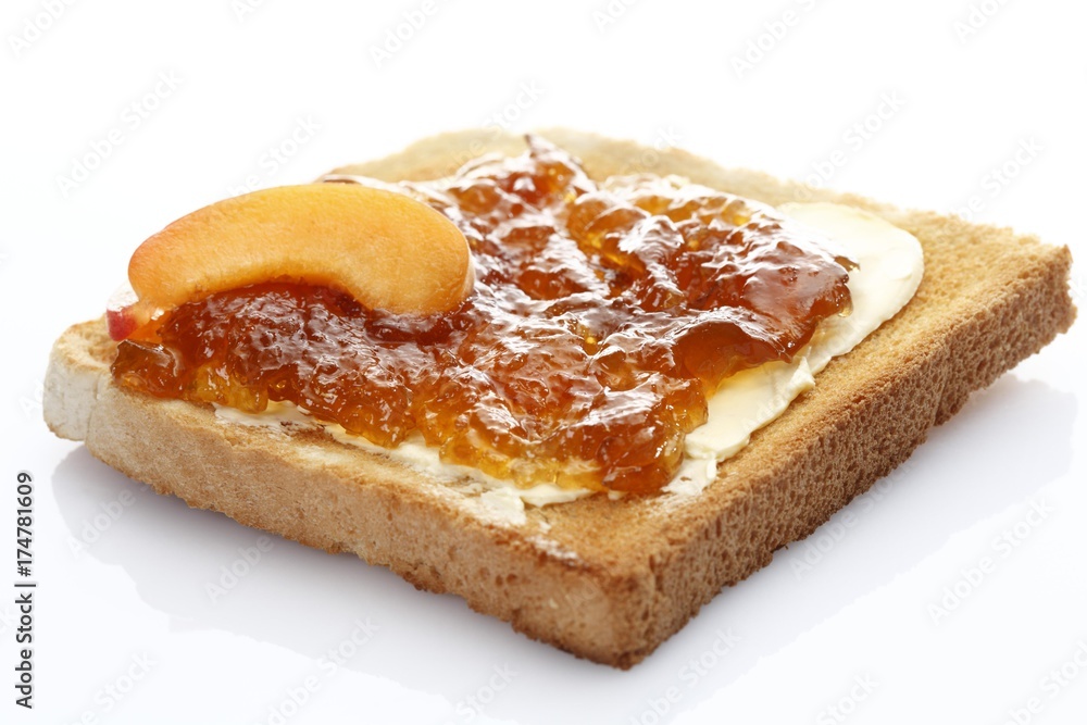 Slice of toast, toasted slice of bread, with apricot jam and apricot pieces Slice of toast, toasted slice of bread, with apricot jam and apricot pieces