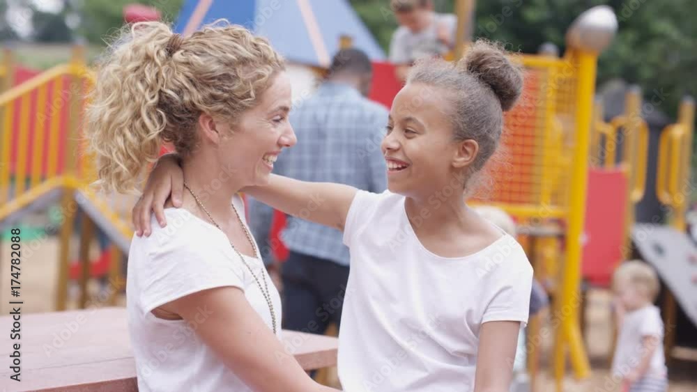 Portrait smiling mixed race mother & daughter at outdoor adventure playground Portrait smiling mixed race mother & daughter at outdoor adventure playground
