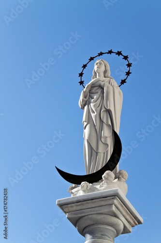 Statue of the Blessed Virgin Mary, Maria Virgen de Regla, on a sandstone church in the center of the Andalusian town of Chipiona, Spain, Europe photo