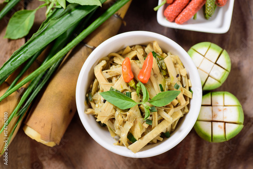 Photos Northern Thai food (Yum Nor Mai),spicy bamboo shoot salad with crab paste on wooden background